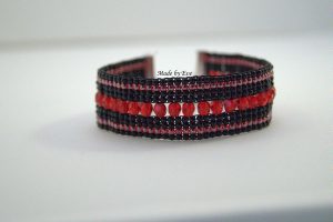 red and black bracelet on loom